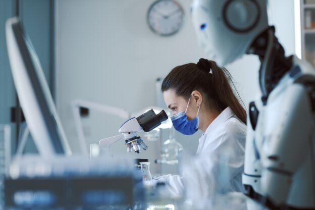 Scientist and humanoid AI robot in the science lab